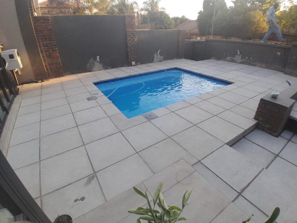 Installed Cosmo pool on a bright paved terrace